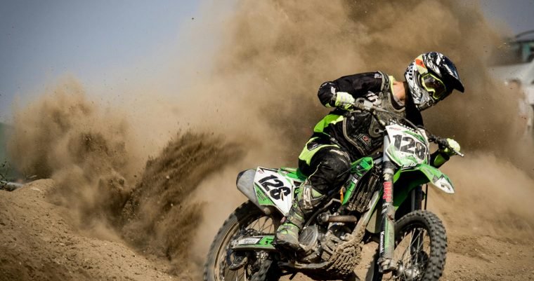 A thrilling motocross rider powers through dust in Beckov, Slovakia.